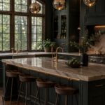 Dark green kitchen with marble island, gold accents, and large arched window.