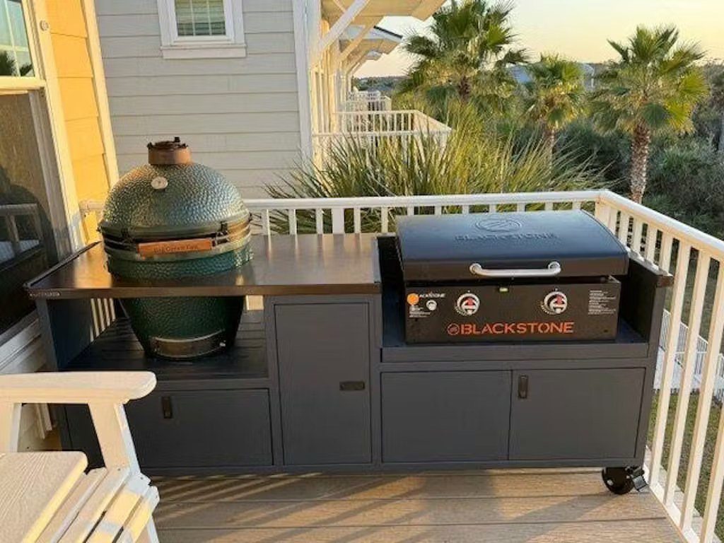 Mobile dark grey grill station with a kamado grill and Blackstone griddle on deck.